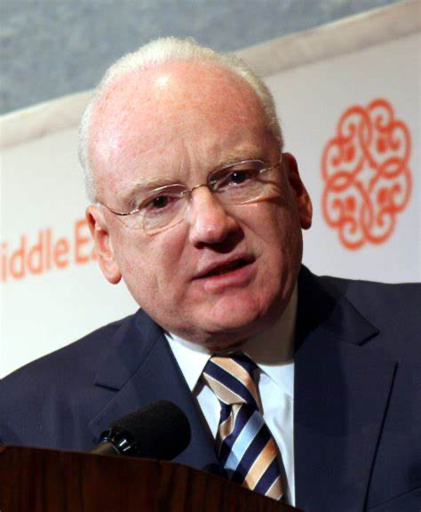 A person in a suit and tieDescription automatically generated with medium confidence