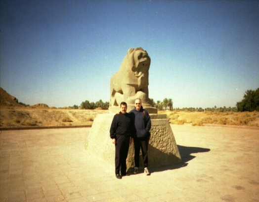 Two people posing in front of a statueDescription automatically generated with medium confidence